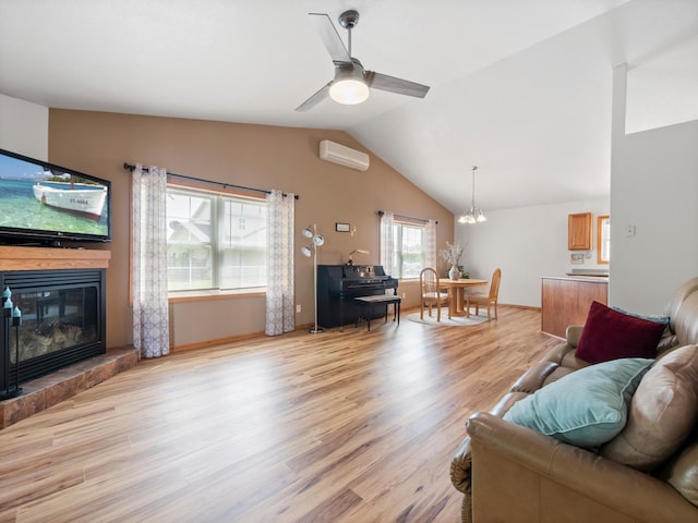 116 Street Cir Unit 104, Miltona, MN 56354 - living area featuring an AC wall unit, light wood-style floors, vaulted ceiling, a ceiling fan, and a glass covered fireplace