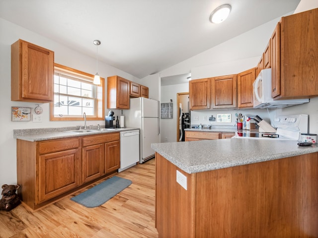 116 Street Cir Unit 104, Miltona, MN 56354 - kitchen featuring white appliances, a sink, lofted ceiling, a peninsula, and light wood finished floors