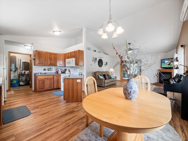 116 Street Cir Unit 104, Miltona, MN 56354 - dining area featuring vaulted ceiling, light wood-type flooring, a chandelier, and a wall mounted AC