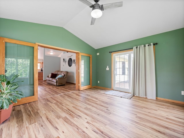 116 Street Cir Unit 104, Miltona, MN 56354 - spare room featuring lofted ceiling, wood finished floors, a ceiling fan, and baseboards
