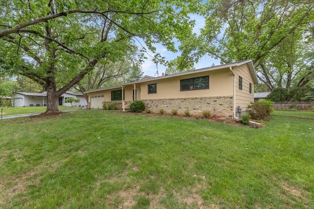 single story home with brick siding, a garage, and a front lawn