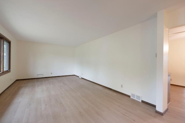 spare room with light wood-style flooring and baseboards