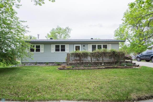 ranch-style house with a front lawn and a deck
