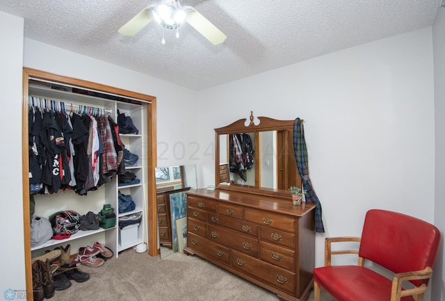 bedroom with carpet floors, a textured ceiling, a closet, and a ceiling fan