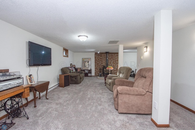carpeted living room featuring a wood stove, a textured ceiling, and baseboards