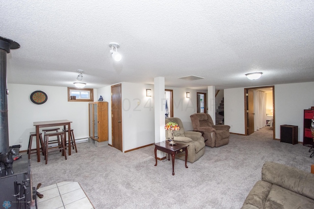 living area featuring a textured ceiling and carpet floors