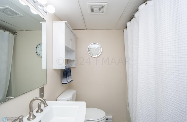 bathroom featuring toilet and a sink