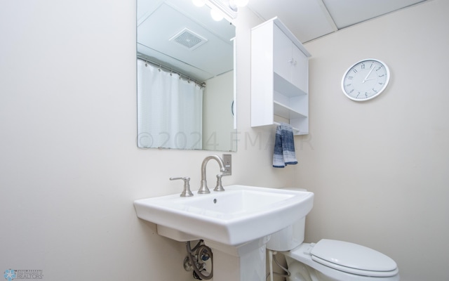 full bathroom with toilet and a sink