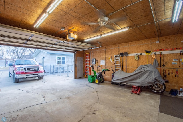 garage with a garage door opener and ceiling fan