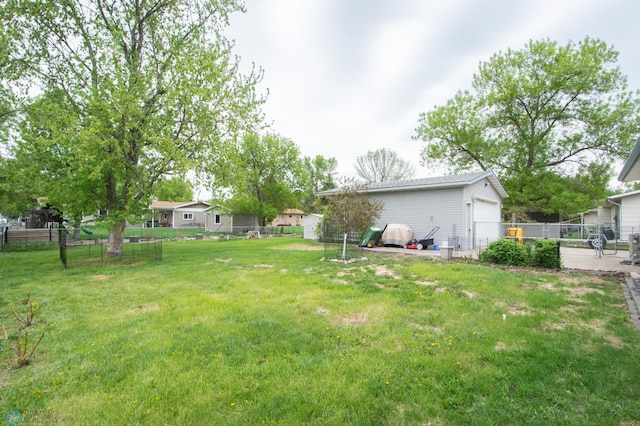 view of yard with an outbuilding and a detached garage