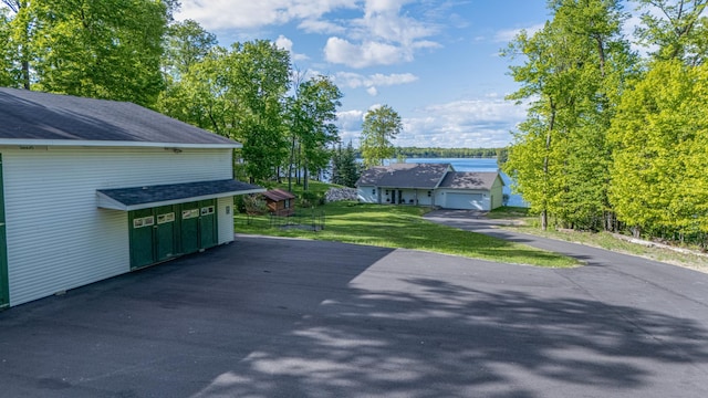 23324 Tioga Beach Rd, Cohasset, MN 55721 - view of patio with asphalt driveway and a garage