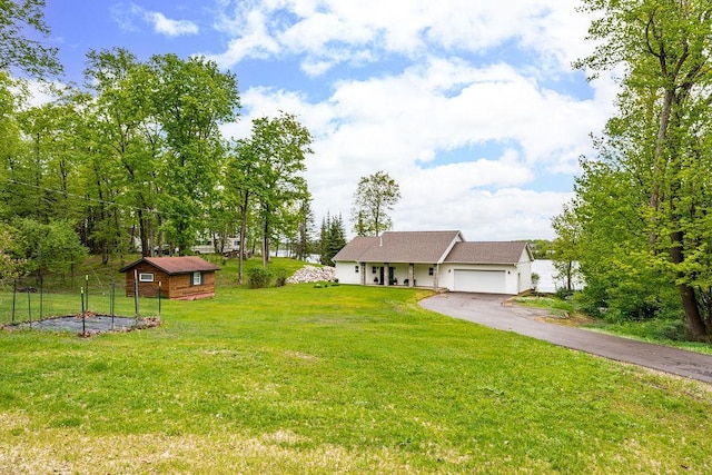 23324 Tioga Beach Rd, Cohasset, MN 55721 - view of green lawn featuring driveway, an attached garage, and an outbuilding