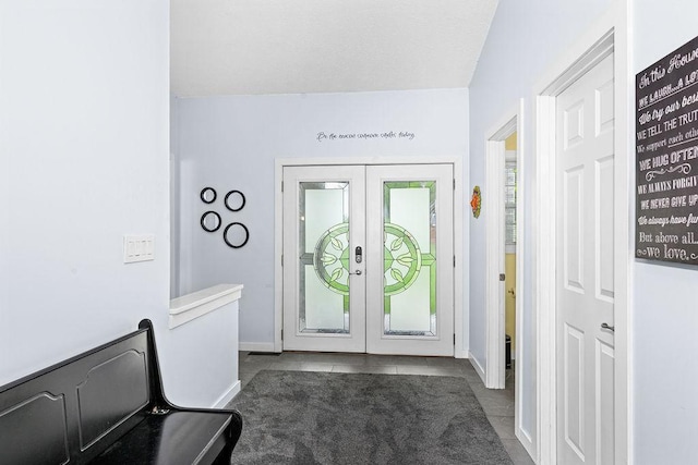 23324 Tioga Beach Rd, Cohasset, MN 55721 - entryway with french doors, dark tile patterned floors, and baseboards