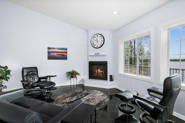 23324 Tioga Beach Rd, Cohasset, MN 55721 - living room featuring granite floors, baseboards, a glass covered fireplace, and recessed lighting