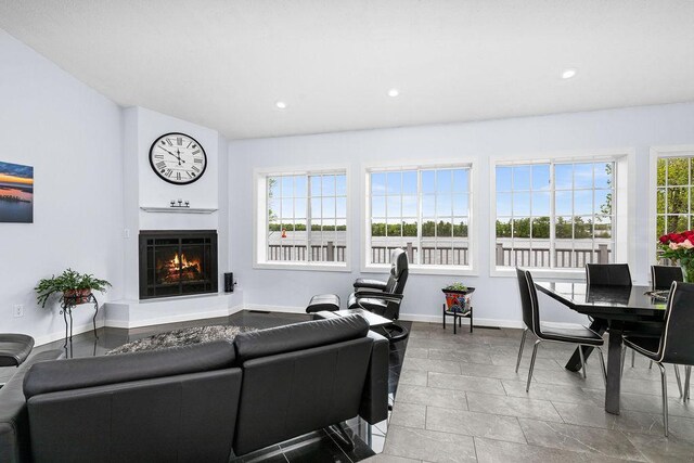 23324 Tioga Beach Rd, Cohasset, MN 55721 - living room featuring a warm lit fireplace, baseboards, and recessed lighting