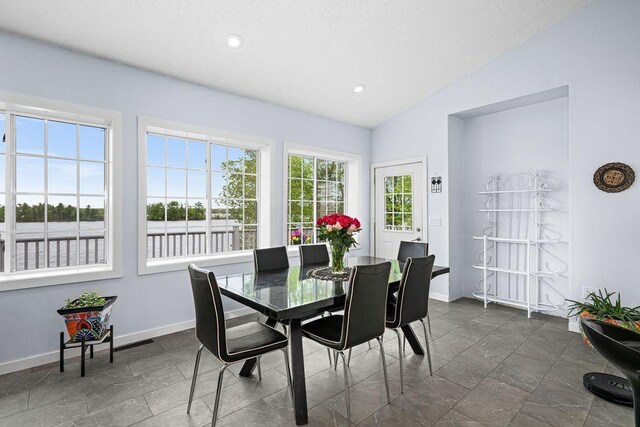 23324 Tioga Beach Rd, Cohasset, MN 55721 - dining area featuring vaulted ceiling, baseboards, and recessed lighting