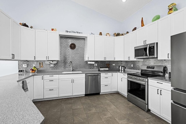 23324 Tioga Beach Rd, Cohasset, MN 55721 - kitchen featuring stainless steel appliances, a sink, lofted ceiling, decorative backsplash, and white cabinets