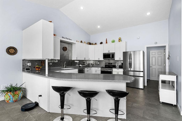 23324 Tioga Beach Rd, Cohasset, MN 55721 - kitchen with appliances with stainless steel finishes, a sink, a peninsula, white cabinets, and a kitchen breakfast bar