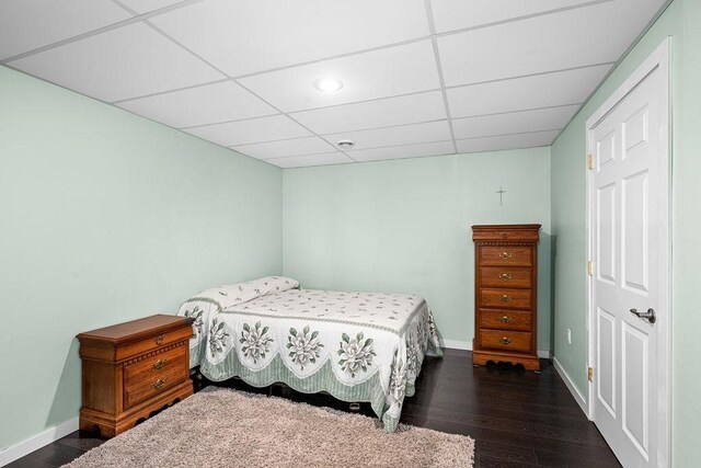 23324 Tioga Beach Rd, Cohasset, MN 55721 - bedroom with baseboards, a drop ceiling, and dark wood-style flooring