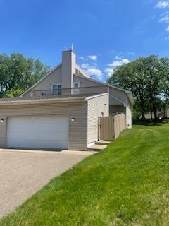 5611 Bavarian Pass, Fridley, MN 55432 - view of side of property featuring a lawn and a chimney