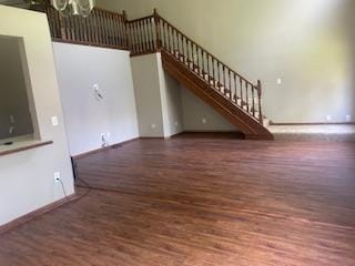5611 Bavarian Pass, Fridley, MN 55432 - unfurnished living room with wood finished floors, stairway, a chandelier, and baseboards