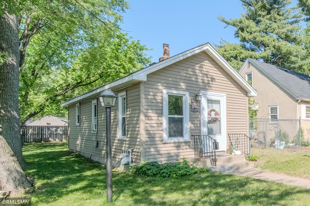 bungalow featuring a chimney