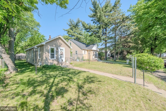 view of front of house featuring a front lawn and a chimney