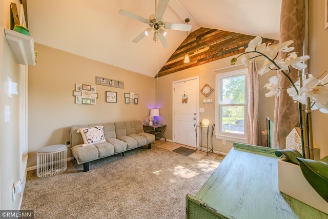 carpeted living area featuring a ceiling fan and baseboards