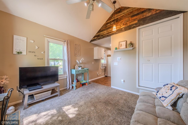carpeted living area with baseboards and a ceiling fan