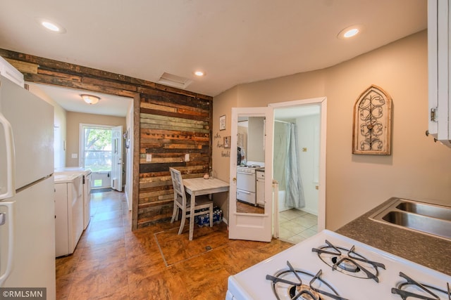 kitchen with white appliances, white cabinets, tile patterned flooring, a sink, and recessed lighting