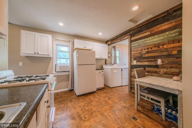 kitchen featuring white appliances, separate washer and dryer, white cabinetry, a sink, and recessed lighting