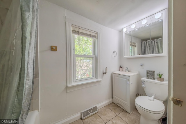 full bathroom with tile patterned flooring, vanity, toilet, baseboards, and shower / tub combo