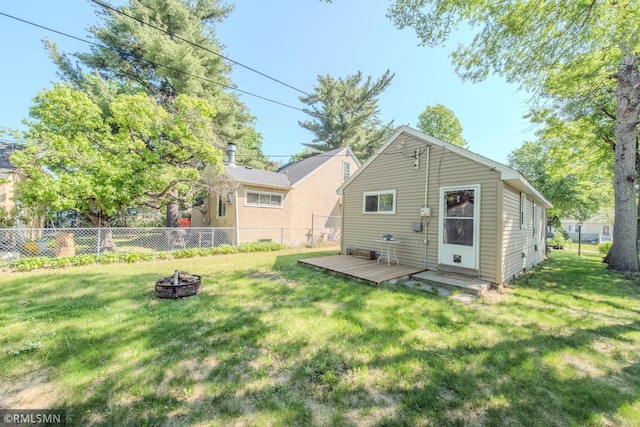 rear view of house featuring an outdoor fire pit and a wooden deck
