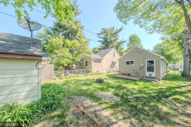 view of yard featuring a fire pit and a wooden deck