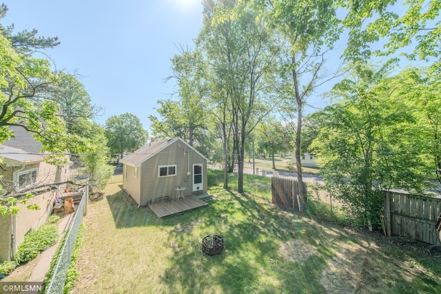 view of yard with a deck and an outdoor structure