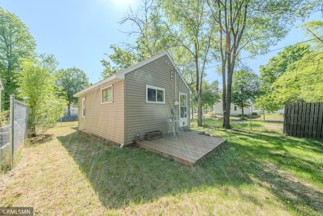 back of house featuring a wooden deck