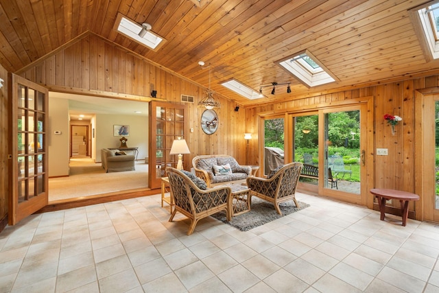 14 Overlook Rd, Dellwood, MN 55110 - living room with a skylight, vaulted ceiling, wooden walls, light tile patterned floors, and wood ceiling