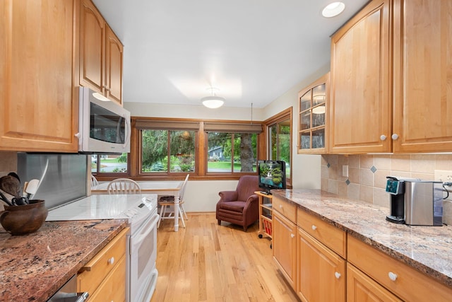 14 Overlook Rd, Dellwood, MN 55110 - kitchen with white appliances, light wood-style floors, tasteful backsplash, light stone countertops, and glass insert cabinets
