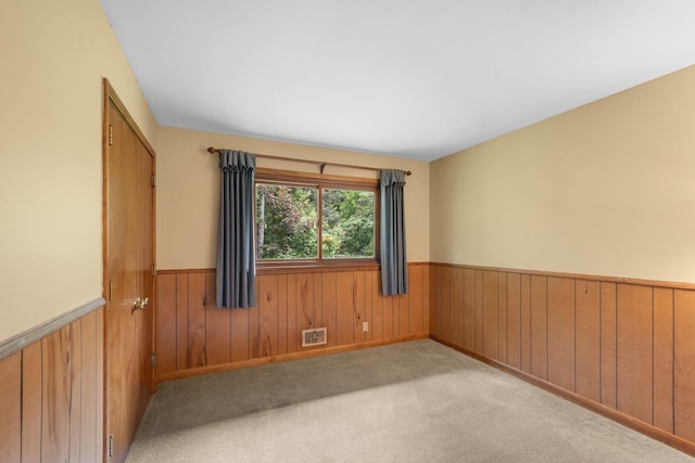 14 Overlook Rd, Dellwood, MN 55110 - unfurnished room featuring wainscoting, wooden walls, and carpet