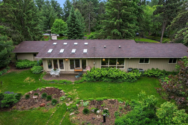 14 Overlook Rd, Dellwood, MN 55110 - back of house featuring a patio, a shingled roof, a lawn, and a view of trees