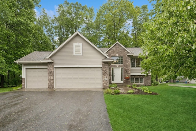 5101 201st St N, Forest Lake, MN 55025 - view of front of home with asphalt driveway, brick siding, a garage, a front lawn, and roof with shingles