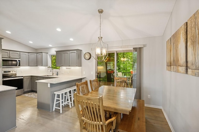 5101 201st St N, Forest Lake, MN 55025 - dining room featuring vaulted ceiling, a chandelier, light wood-type flooring, recessed lighting, and baseboards