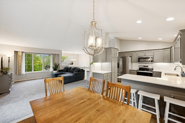 5101 201st St N, Forest Lake, MN 55025 - dining space with vaulted ceiling, a chandelier, carpet flooring, recessed lighting, and baseboards