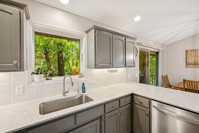 5101 201st St N, Forest Lake, MN 55025 - kitchen featuring stainless steel dishwasher, a sink, gray cabinets, tasteful backsplash, and light stone counters