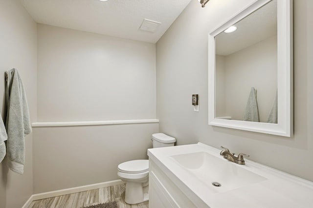 5101 201st St N, Forest Lake, MN 55025 - half bath featuring vanity, toilet, wood finished floors, and baseboards