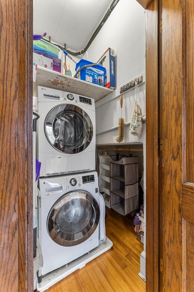2895 James Ave S Unit 2, Minneapolis, MN 55408 - clothes washing area featuring stacked washer and clothes dryer and wood-type flooring