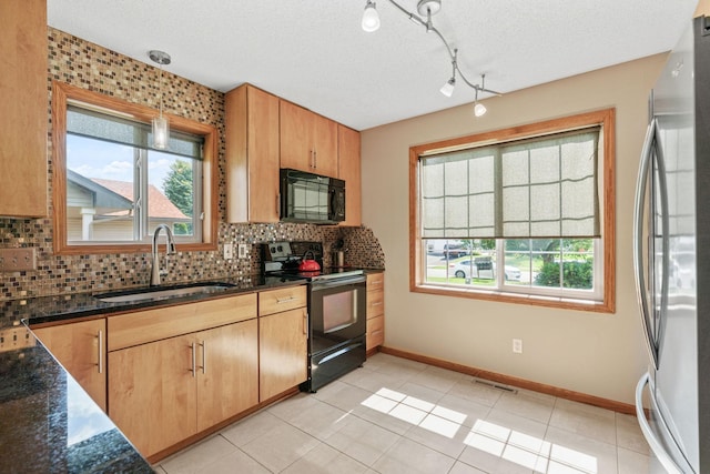 7734 Lancaster Ave NE, Otsego, MN 55301 - kitchen with black appliances, healthy amount of natural light, decorative backsplash, and a textured ceiling