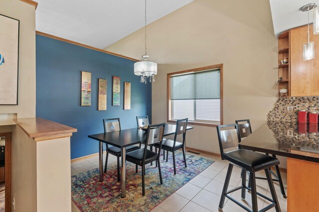 7734 Lancaster Ave NE, Otsego, MN 55301 - dining room with light tile patterned floors, vaulted ceiling, a chandelier, and ornamental molding