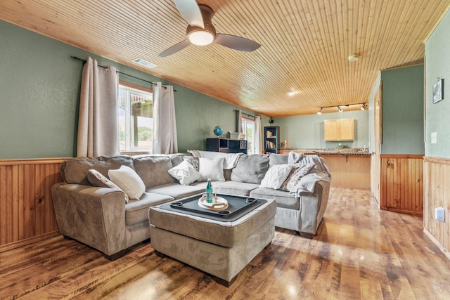 7734 Lancaster Ave NE, Otsego, MN 55301 - living room with light wood-style floors, wood walls, wainscoting, a ceiling fan, and wood ceiling