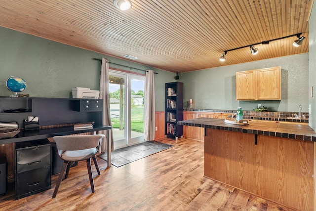 7734 Lancaster Ave NE, Otsego, MN 55301 - kitchen with track lighting, wooden ceiling, light brown cabinetry, a kitchen breakfast bar, and light wood-type flooring
